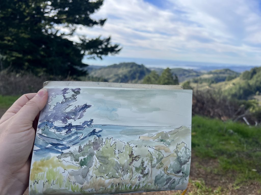 Sketchbook watercolor of trees, mountains, and ocean done on Harkins Ridge. 